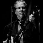 Singer & songwriter Tony Winn playing banjo onstage